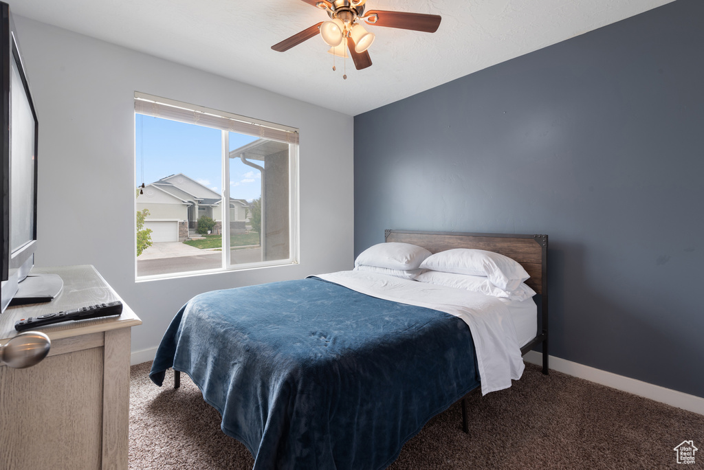 Bedroom featuring baseboards, carpet, and a ceiling fan