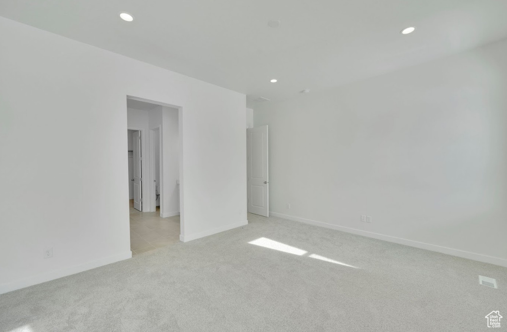 Empty room with recessed lighting, baseboards, and light colored carpet