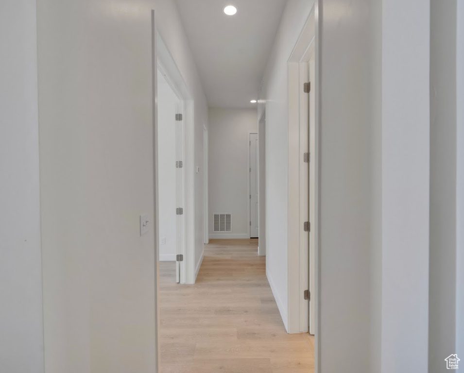 Hallway with baseboards, recessed lighting, light wood-style flooring, and visible vents