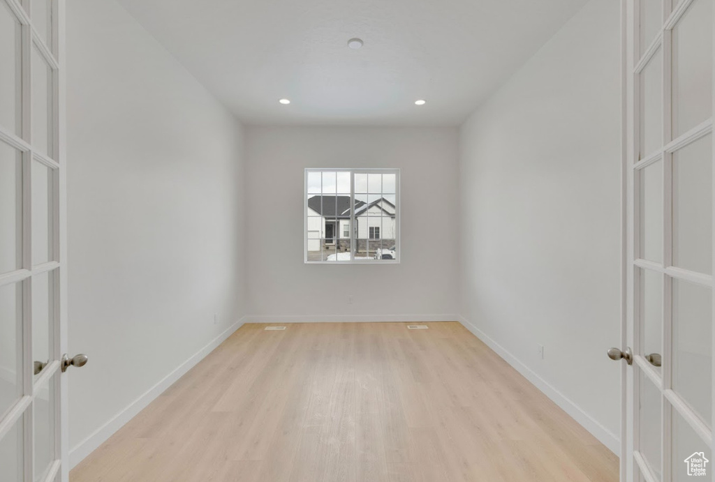 Spare room with recessed lighting, baseboards, french doors, and light wood finished floors