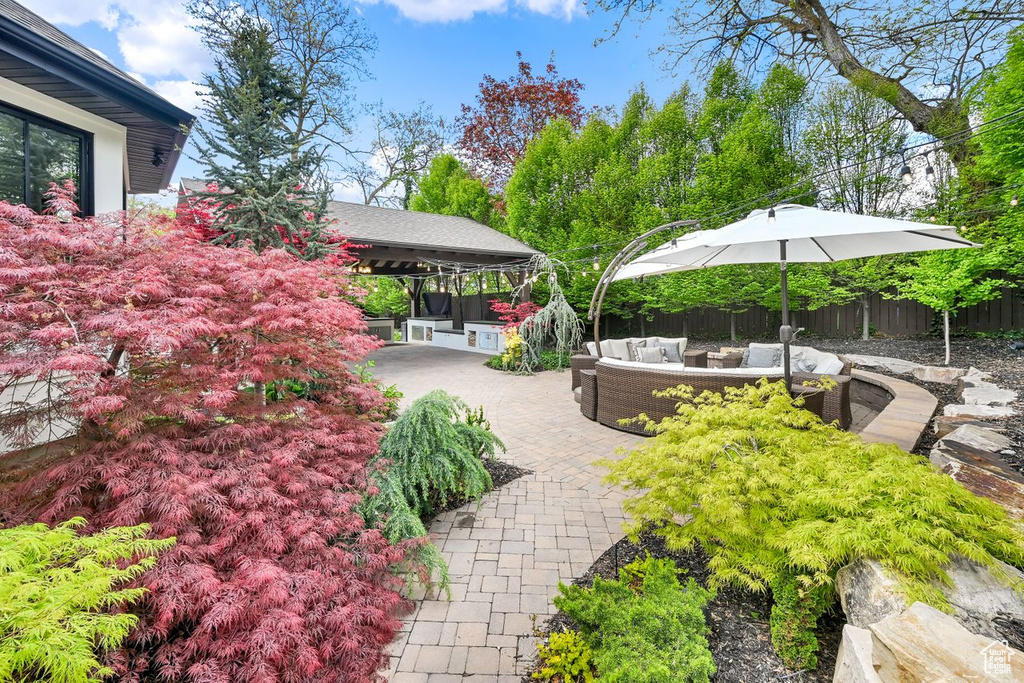 Exterior space featuring an outdoor living space, a patio area, and fence