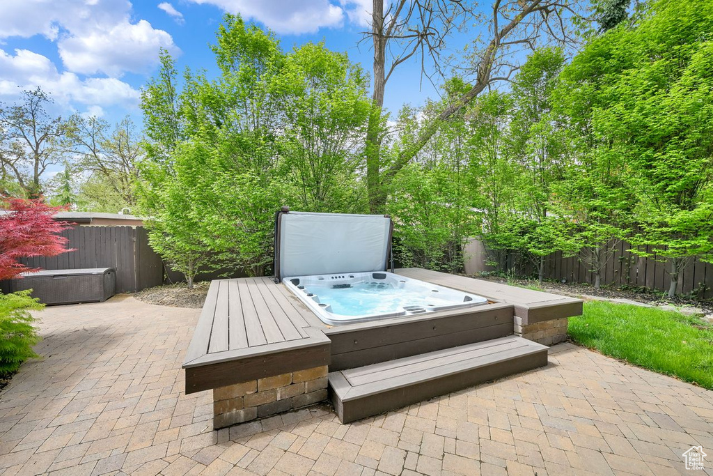 View of patio / terrace featuring a covered hot tub and a fenced backyard