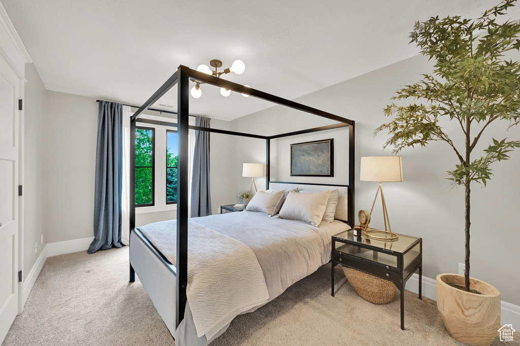 Bedroom with baseboards and light carpet