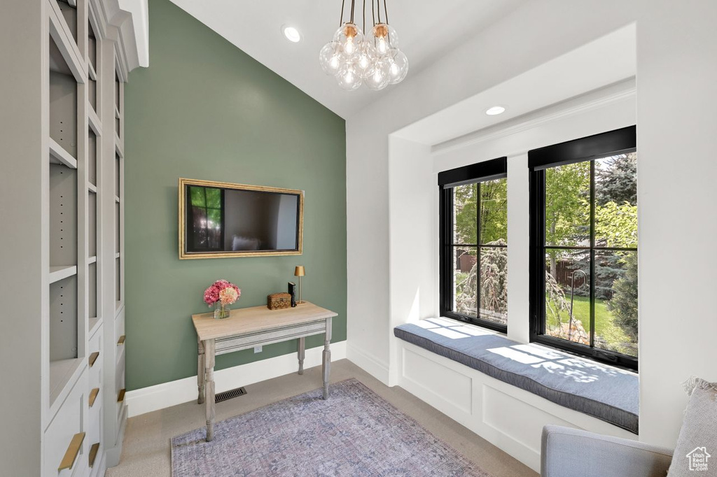 Interior space with baseboards, recessed lighting, a notable chandelier, and light carpet