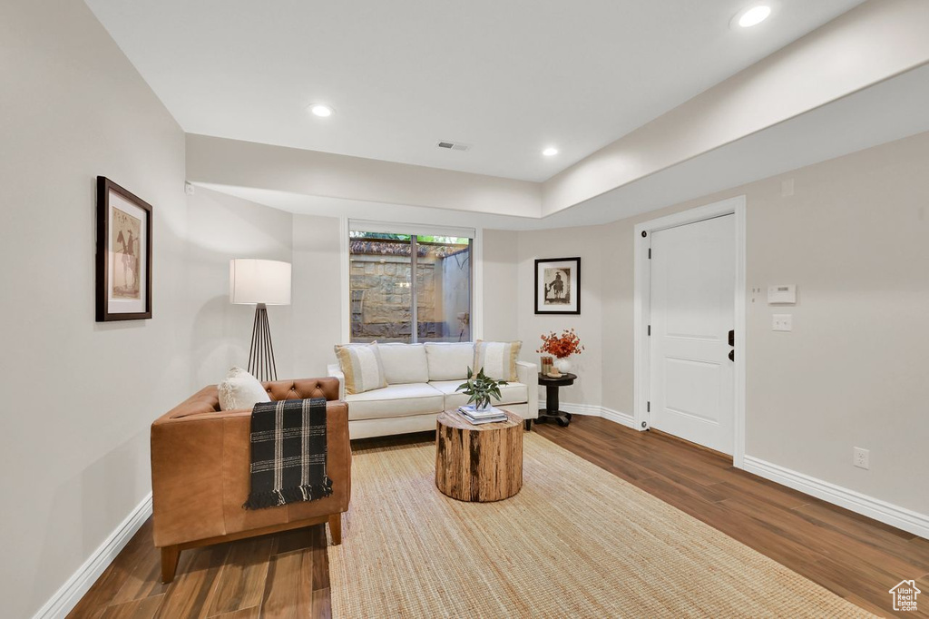 Living area featuring baseboards, recessed lighting, and wood finished floors