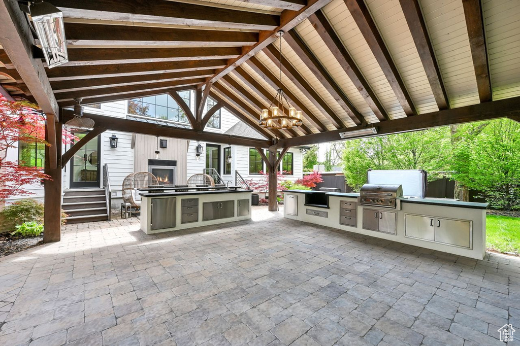 View of patio featuring area for grilling, exterior kitchen, fence, and entry steps