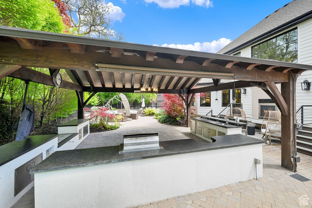 View of patio / terrace with exterior kitchen and a gazebo
