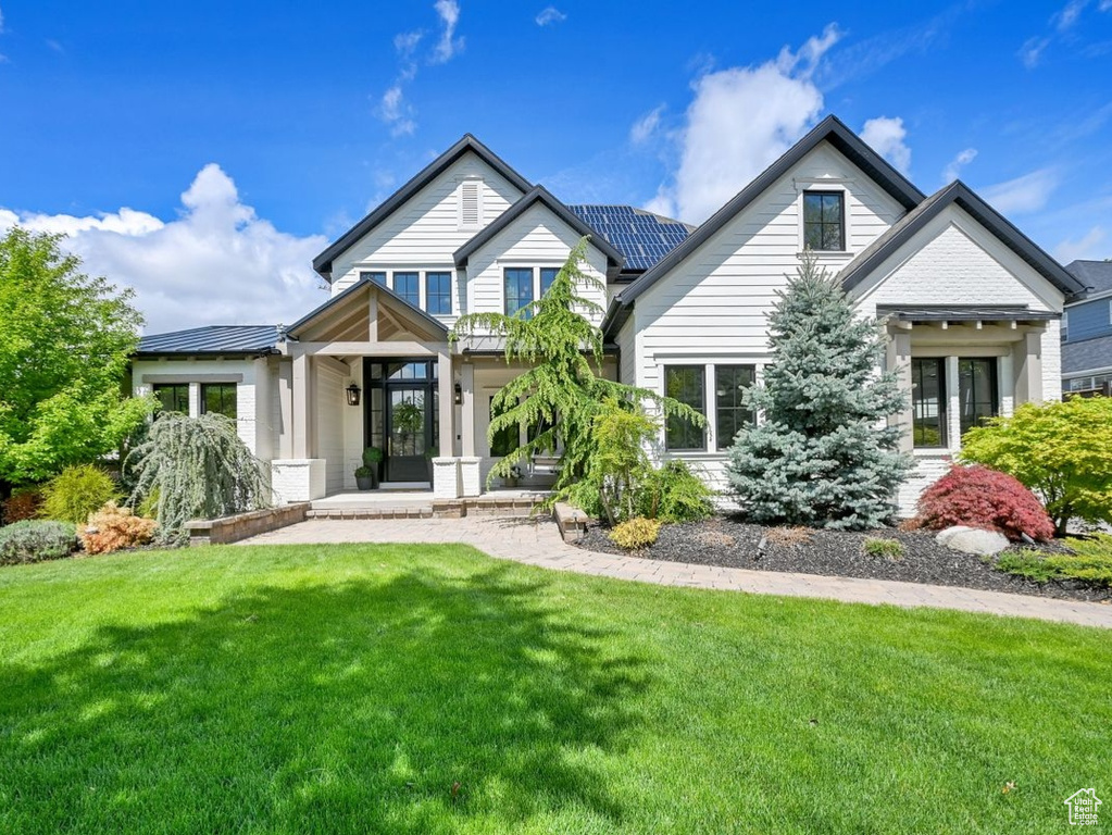 Craftsman-style home with a front lawn
