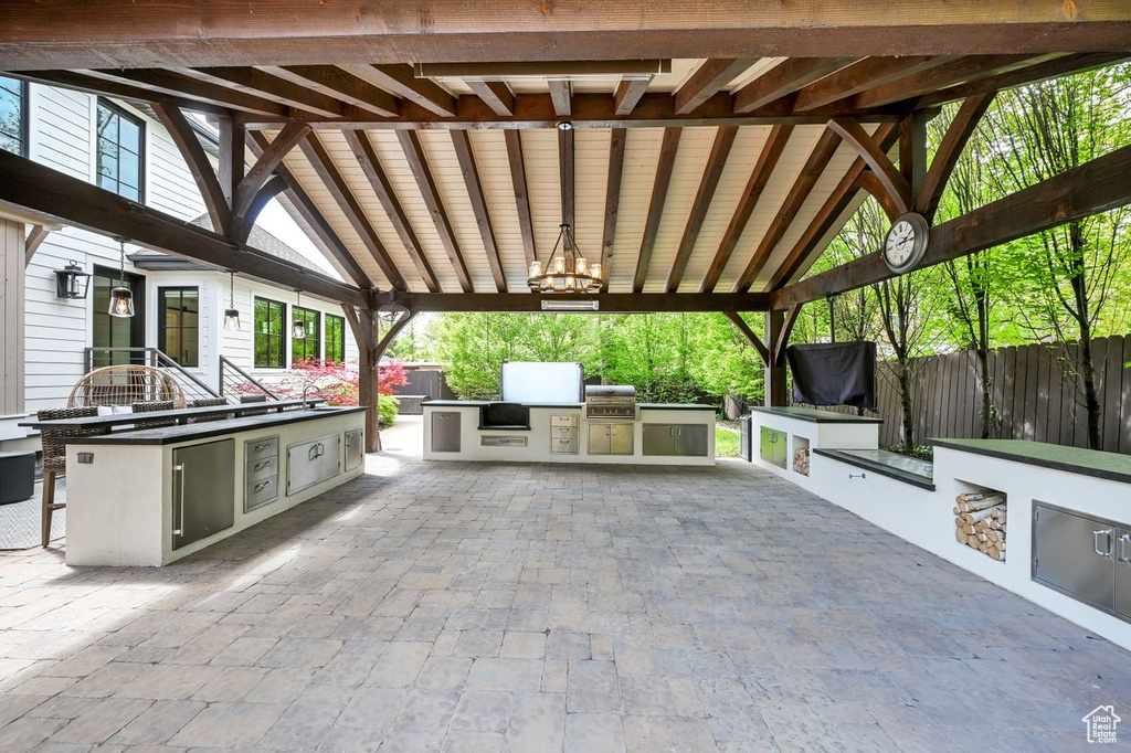 View of patio featuring grilling area, exterior kitchen, and fence