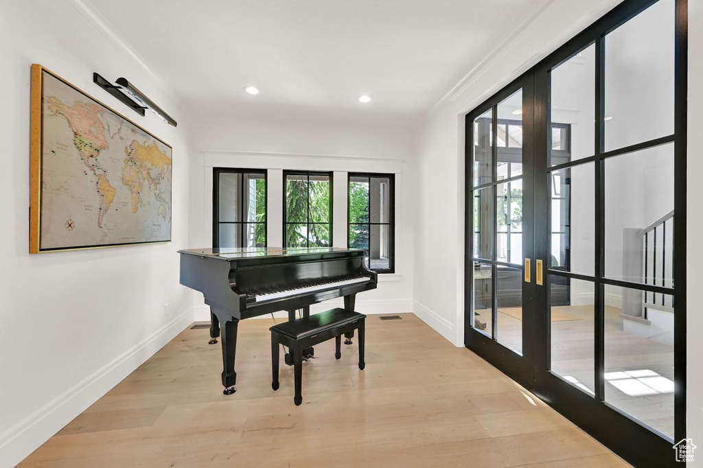 Sitting room with french doors, recessed lighting, baseboards, wood finished floors, and visible vents
