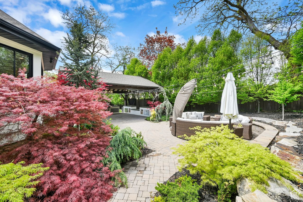 View of home\\\'s community featuring fence, outdoor lounge area, and a patio area