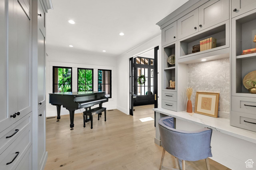 Office area featuring baseboards, recessed lighting, and light wood-style flooring