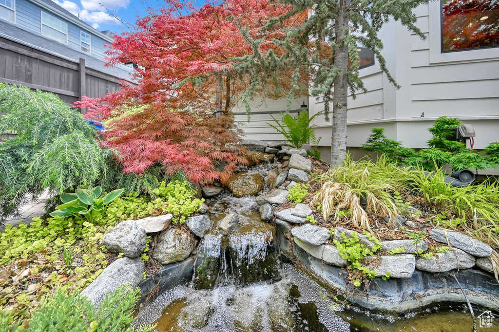 View of yard featuring a small pond