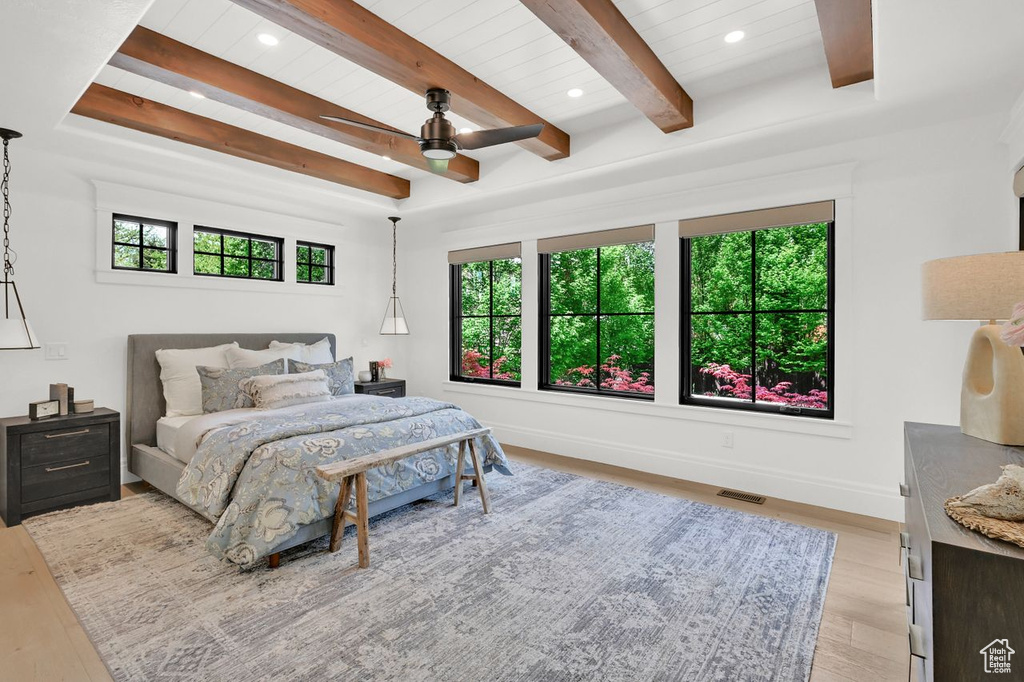 Bedroom featuring multiple windows, light wood-style flooring, and visible vents