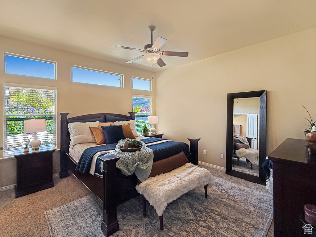 Carpeted bedroom featuring baseboards and a ceiling fan