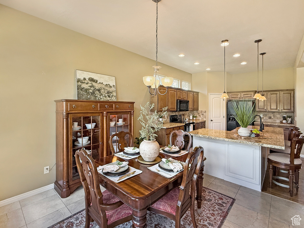 Dining area featuring baseboards, recessed lighting, and a chandelier