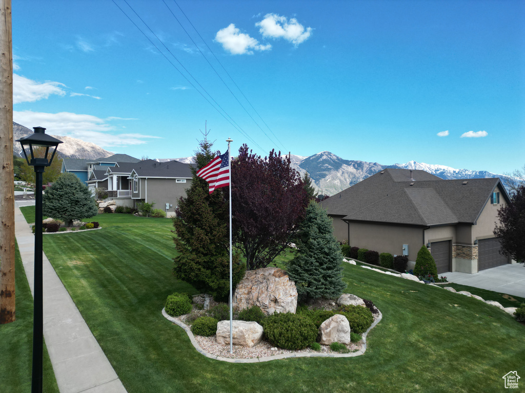 View of yard featuring an attached garage and a mountain view