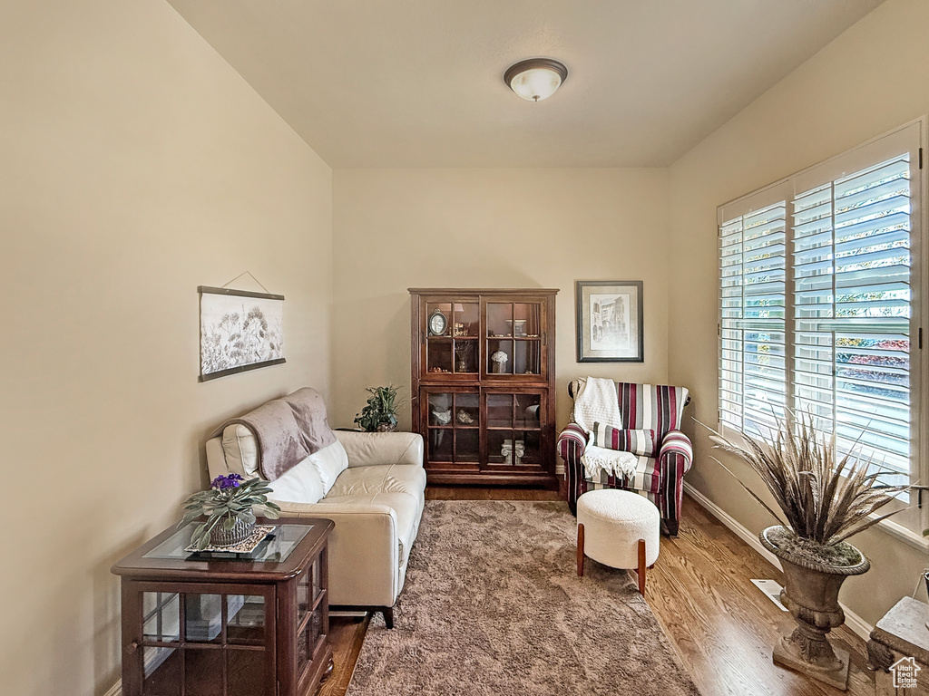 Sitting room featuring baseboards and wood finished floors