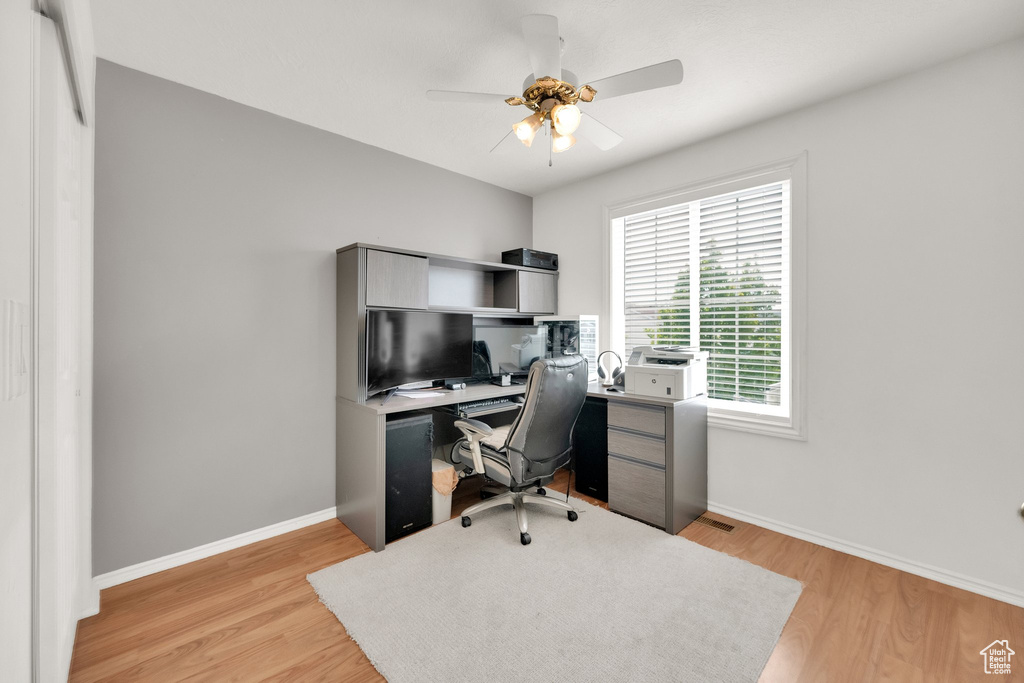 Office area featuring ceiling fan, baseboards, and light wood finished floors