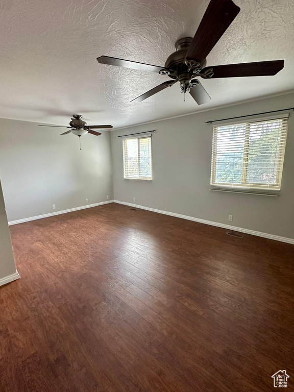 Unfurnished room with a ceiling fan, a textured ceiling, and wood finished floors
