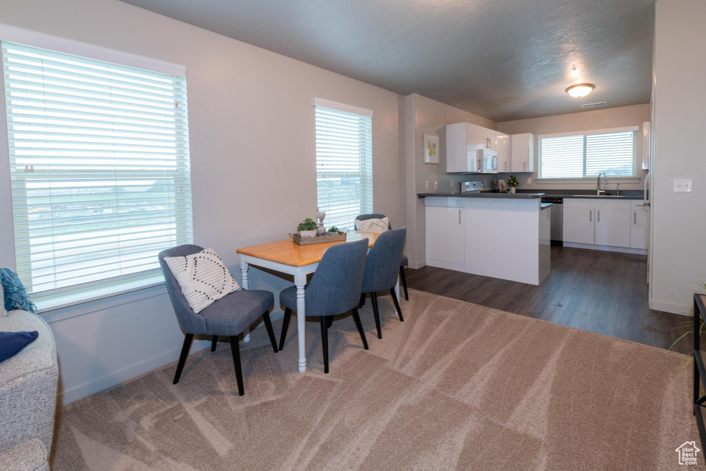 Dining room with baseboards and wood finished floors