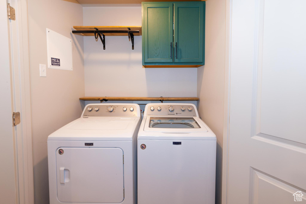 Laundry room with cabinet space and washing machine and clothes dryer