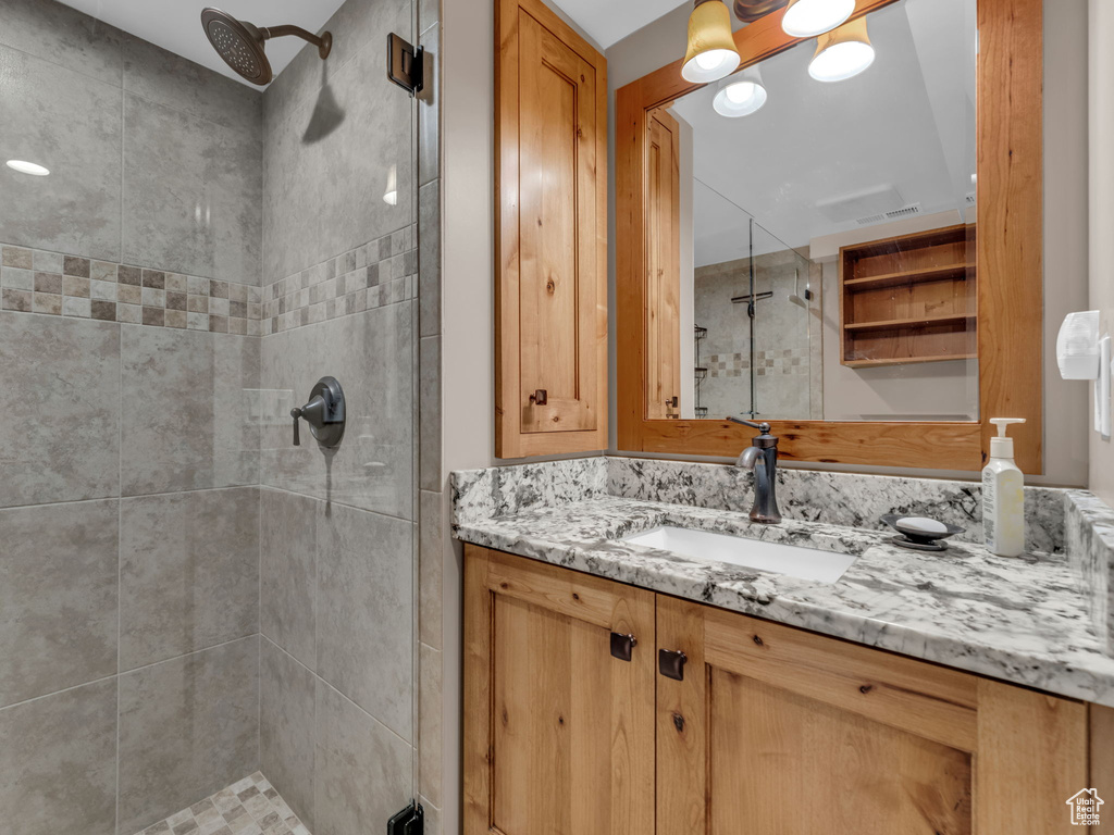 Full bath with vanity and a shower stall