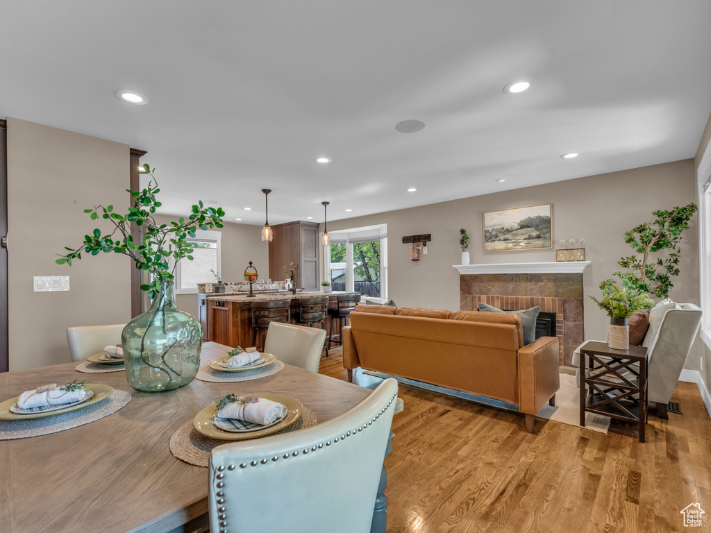 Dining space with a fireplace, recessed lighting, and light wood-style flooring