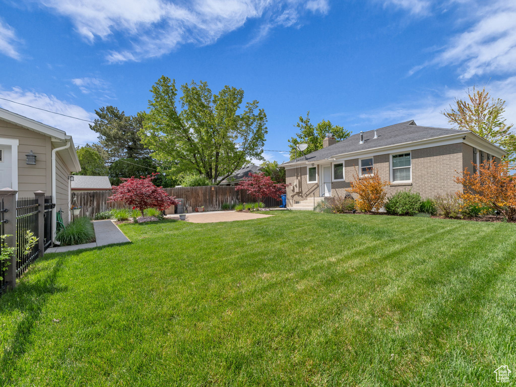 View of yard with a patio and a fenced backyard