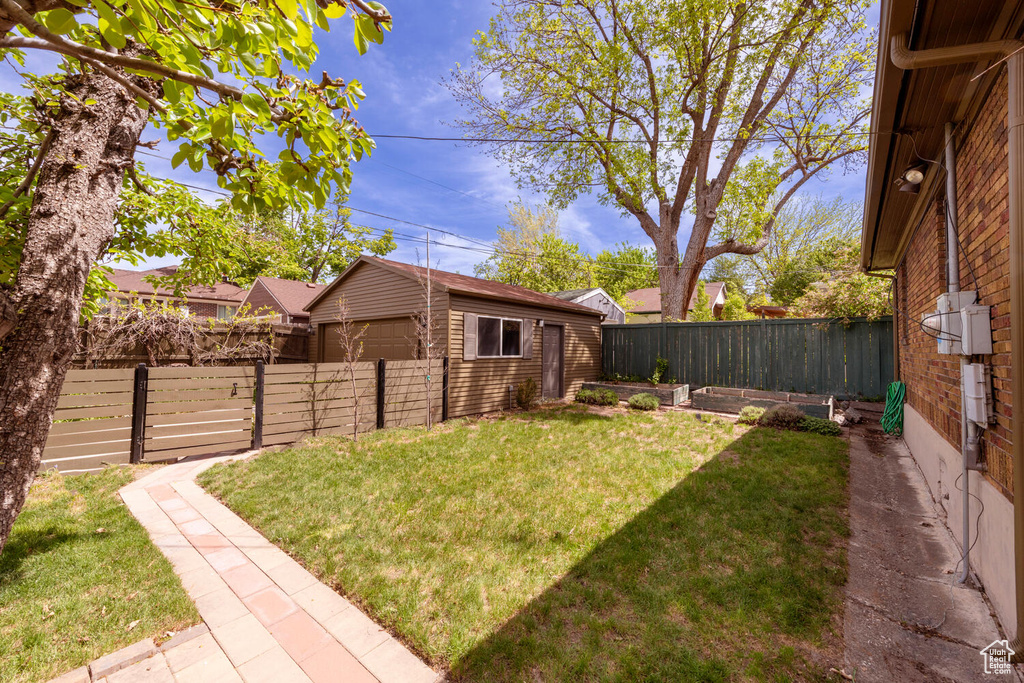 View of yard featuring an outbuilding and a fenced backyard