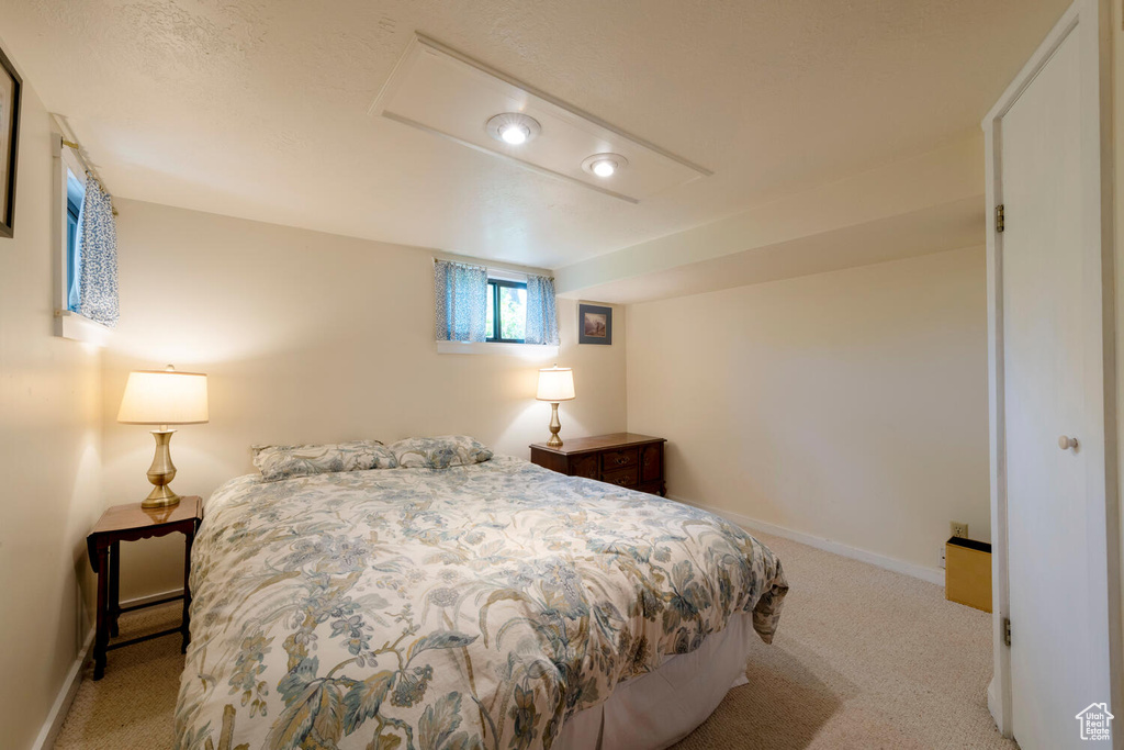 Carpeted bedroom featuring baseboards