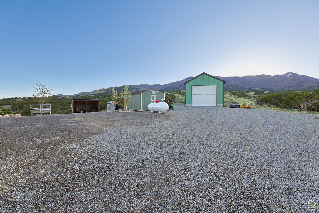 Ranch-style house with an outbuilding, a mountain view, and a garage