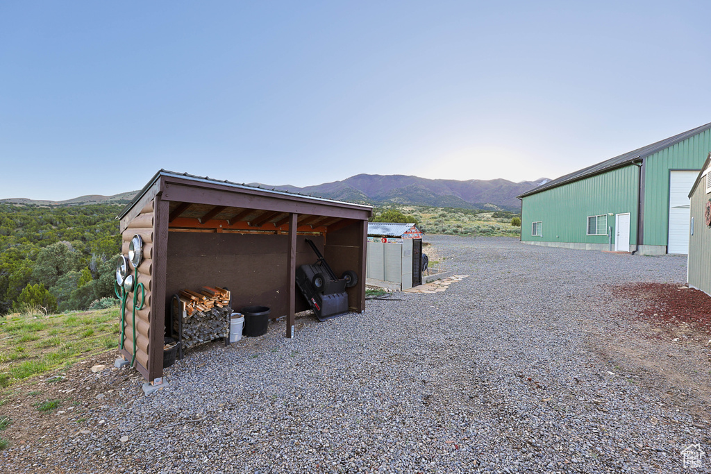 View of pole building with a mountain view