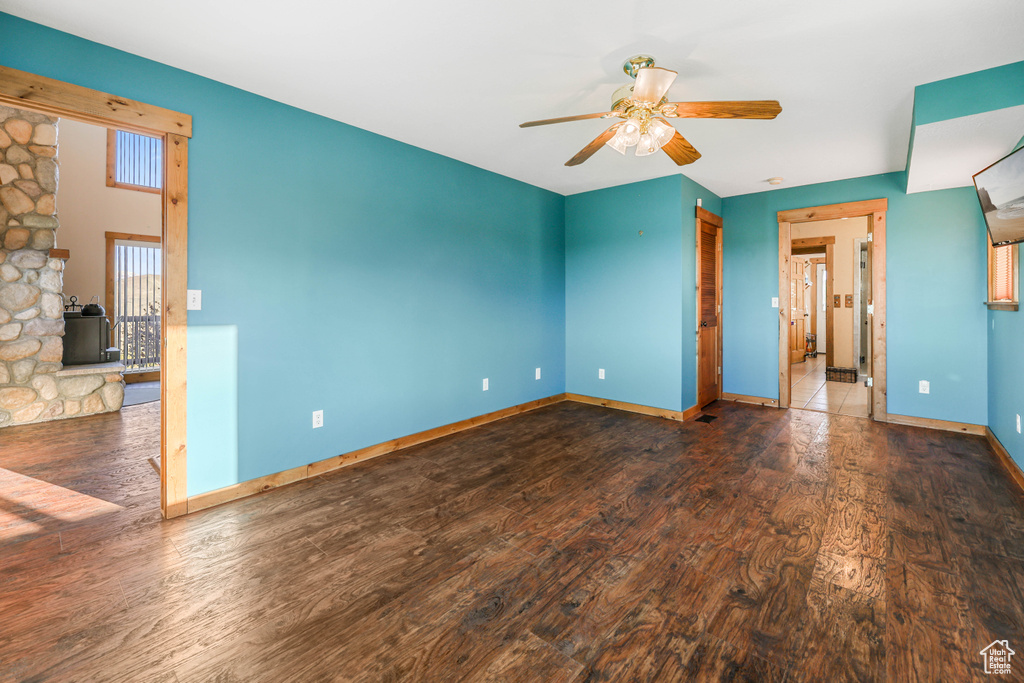 Spare room featuring baseboards, ceiling fan, and wood finished floors