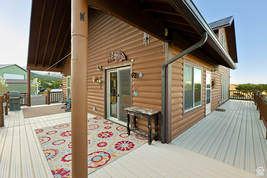 Wooden terrace featuring a grill
