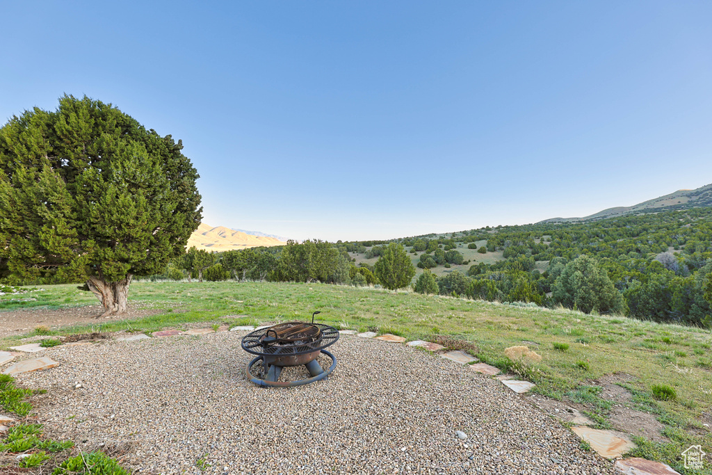 View of yard featuring a fire pit and a mountain view
