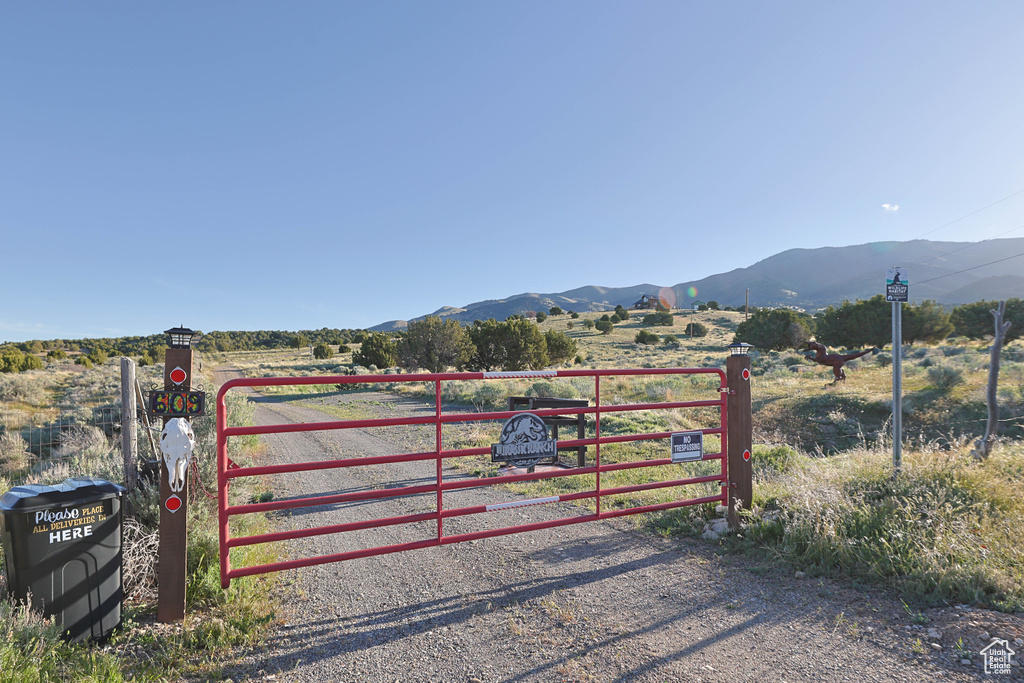 View of gate with a mountain view and a rural view