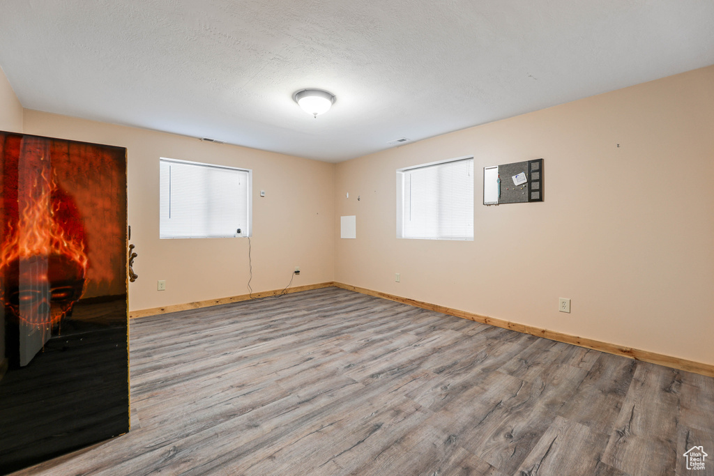 Empty room featuring baseboards and wood finished floors
