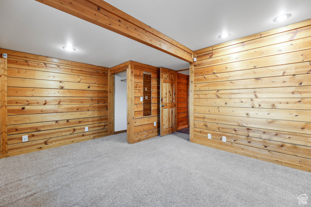 Carpeted empty room with wooden walls