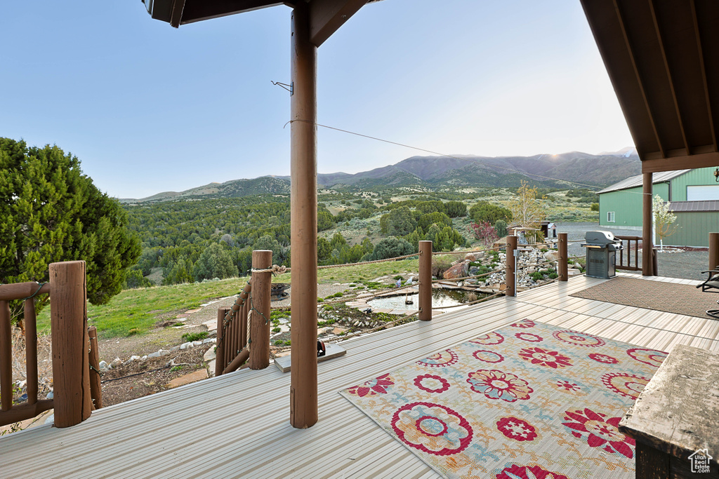 Wooden deck with a mountain view and a grill