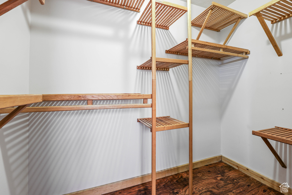Walk in closet featuring wood finished floors