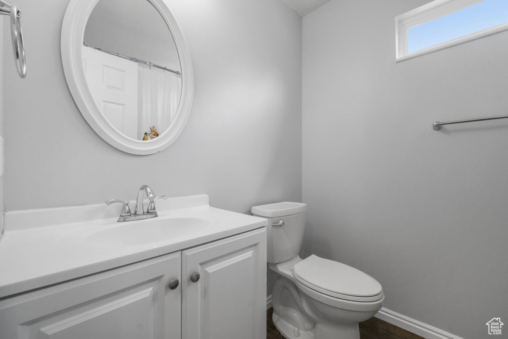 Full bathroom featuring vanity, baseboards, and toilet