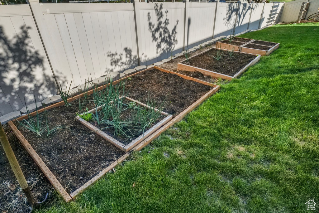 Exterior details featuring fence and a vegetable garden