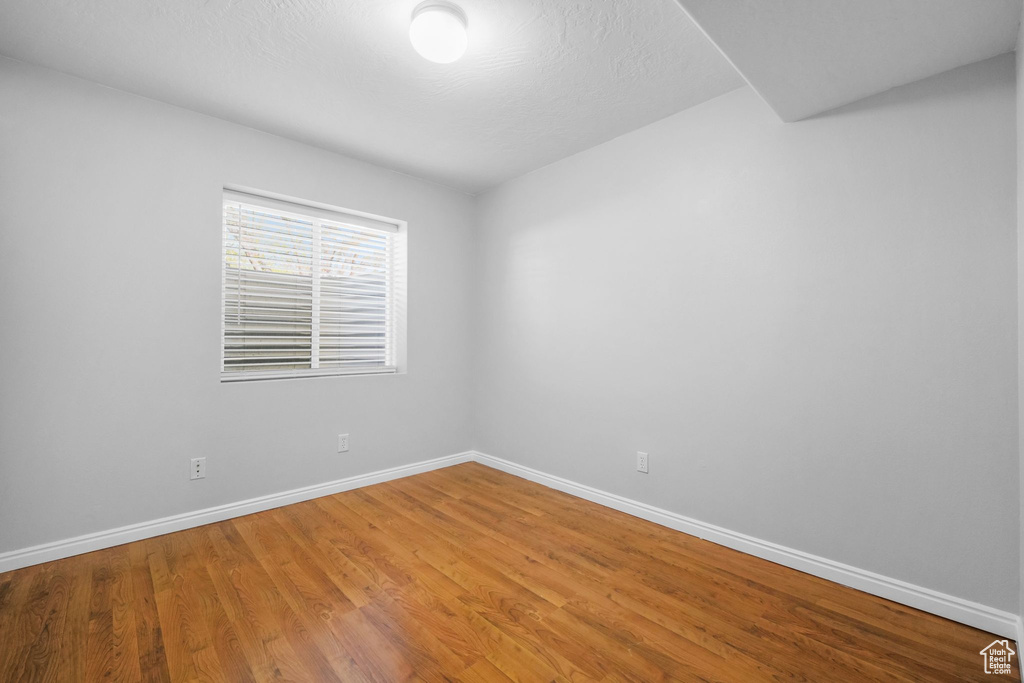 Empty room featuring baseboards and wood finished floors