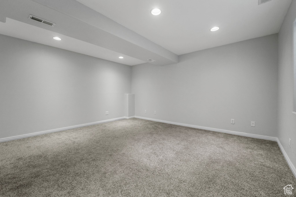 Spare room featuring carpet flooring, recessed lighting, baseboards, and visible vents