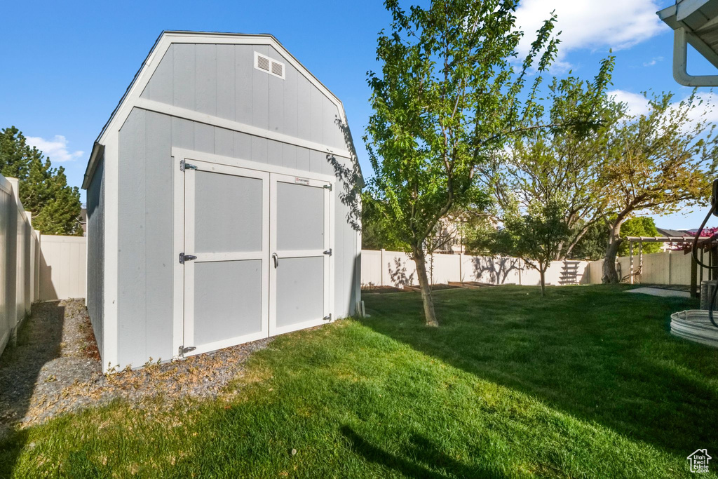 View of shed with a fenced backyard