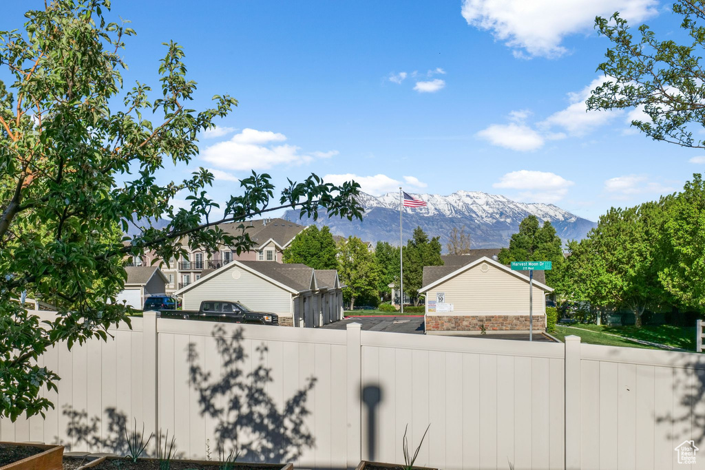 View of yard with a mountain view and fence