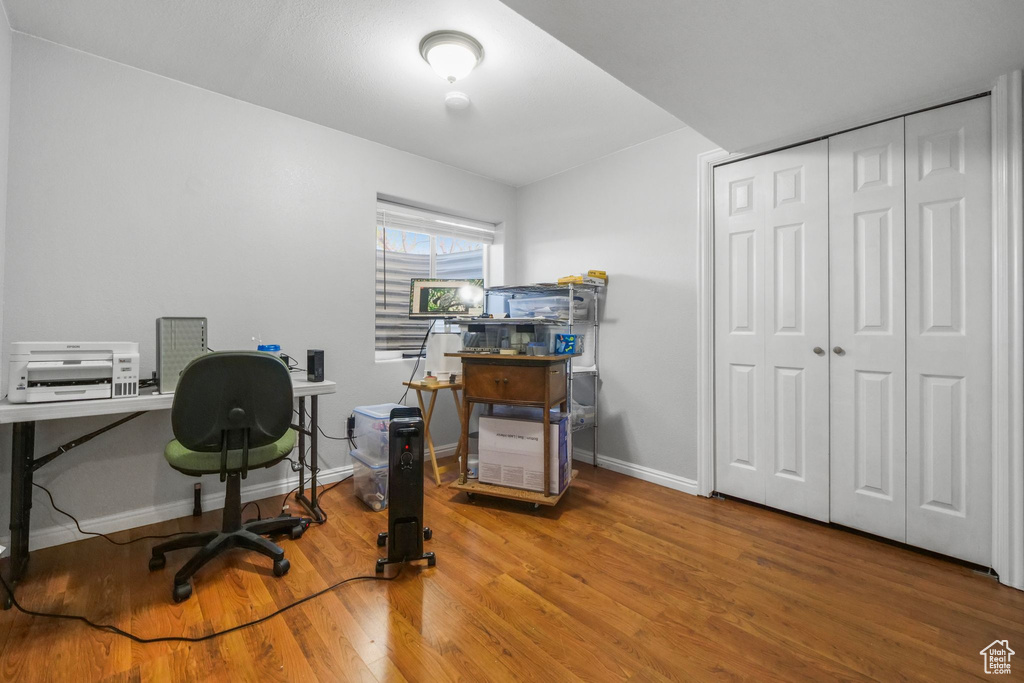 Office space featuring baseboards and wood finished floors