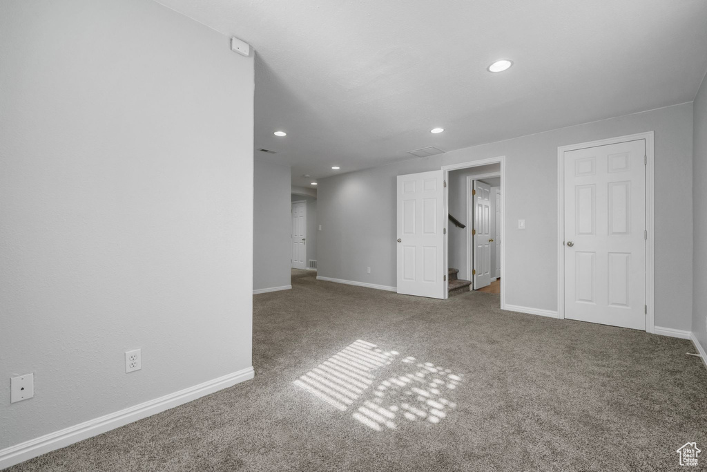 Spare room with recessed lighting, carpet flooring, and baseboards
