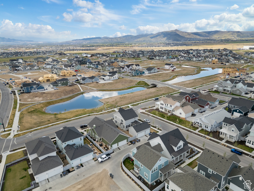 Drone / aerial view featuring a water and mountain view and a residential view